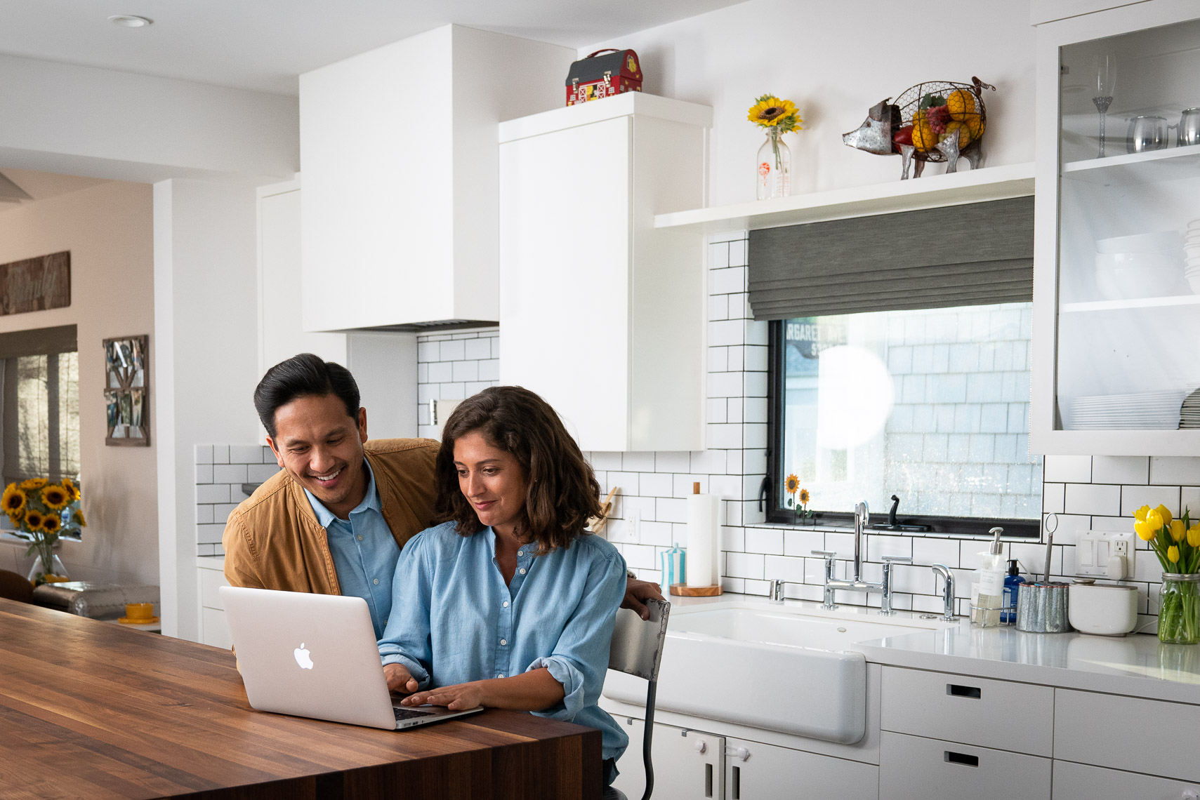 Avast - Couple Working on Laptop in Kitchen