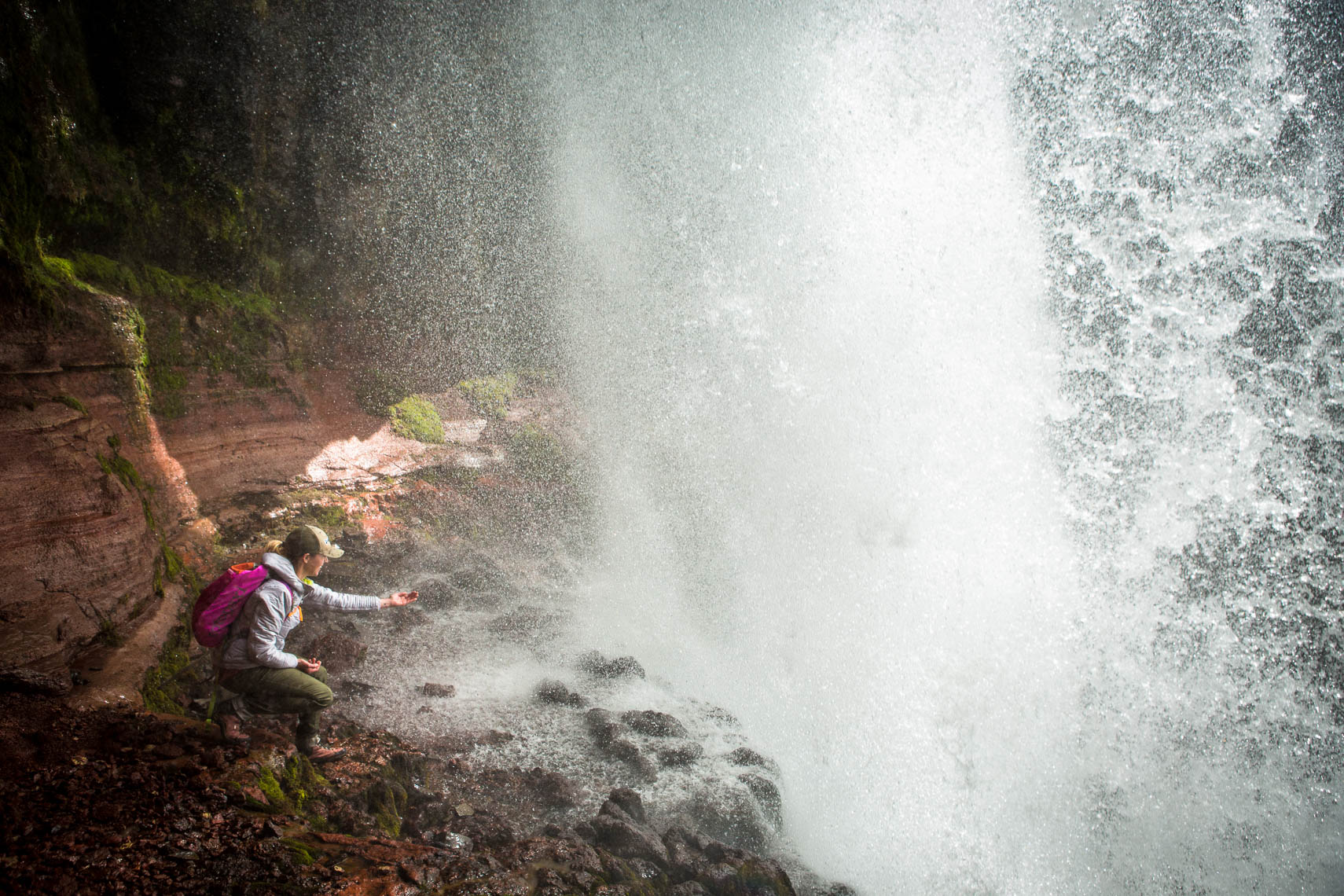Hiker Beneath a Waterfall
