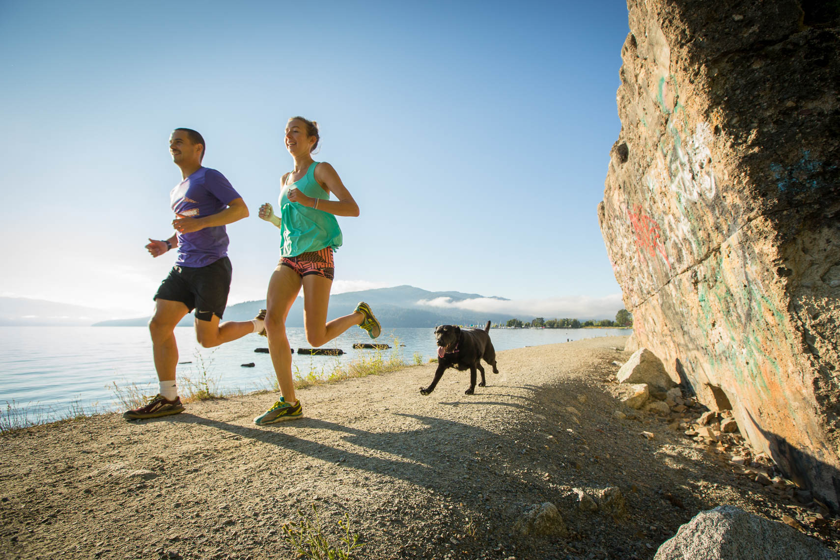 Couple Trail Running with Dog in Sand Point Idaho, Lake Pend Oreille