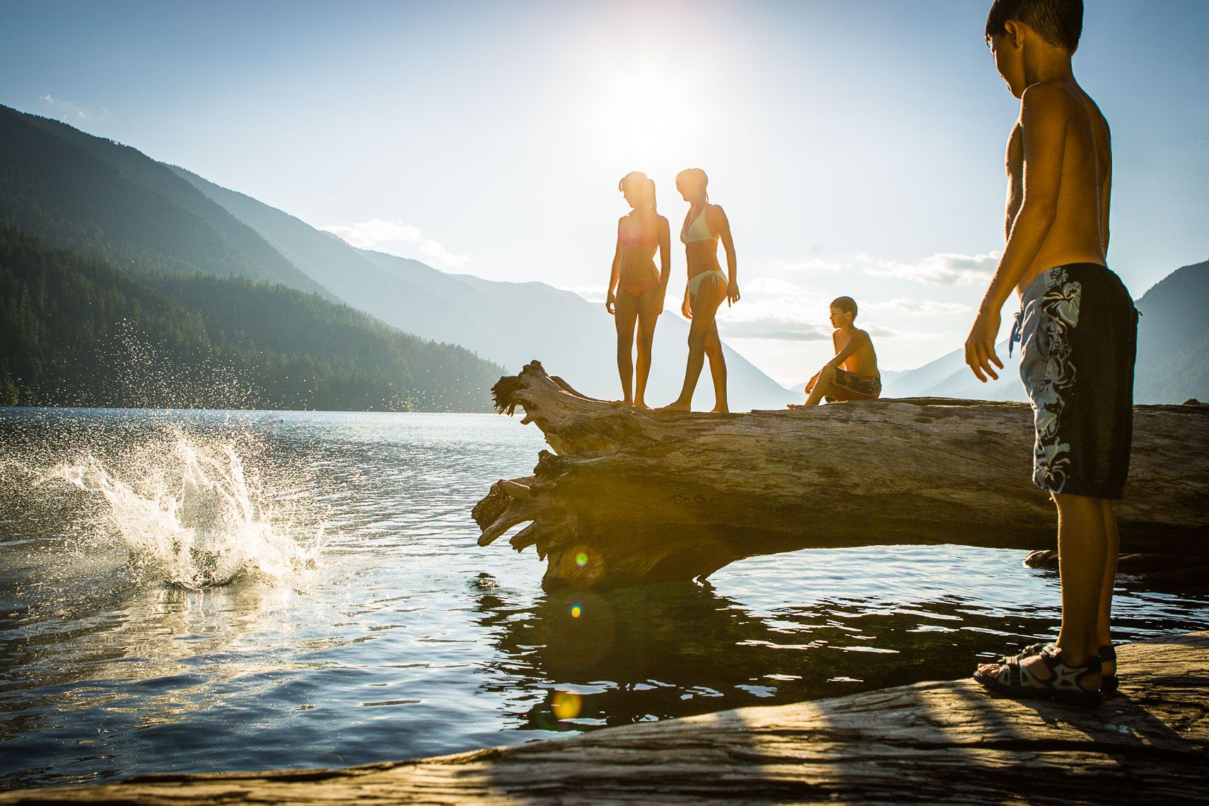 Kids Jumping Off Log Into Lake